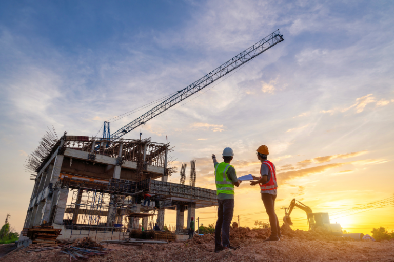 Engineering site surveyors with a sunset in the background